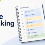 A planner, clock, and pen showing a simple time blocking schedule for planning the day